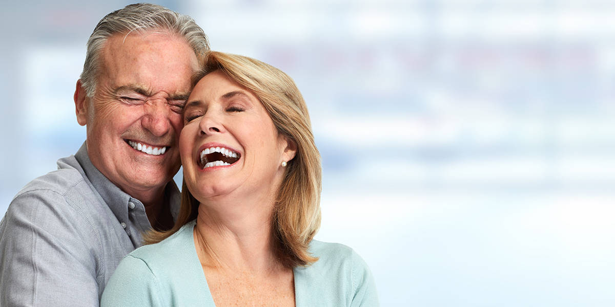 man and woman shows teeth after dental implant toronto - Markham Dentists at Compleo at Dentistry at Vitality Health