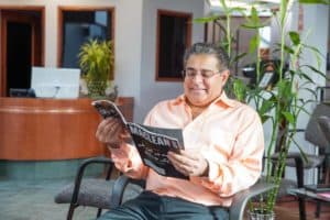 patient reads magazine in dental implant clinic lobby